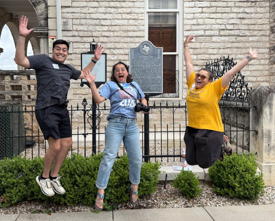 Water Trotter participants taking a picture in front of an Austin landmark